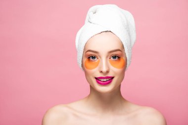 cheerful naked girl with eye patches isolated on pink 