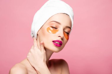naked girl with eye patches and closed eyes isolated on pink 