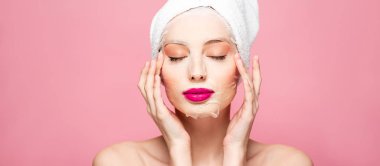 panoramic shot of naked woman in moisturizing face mask with closed eyes isolated on pink 
