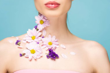 cropped view of woman with flowers on neck isolated on blue 