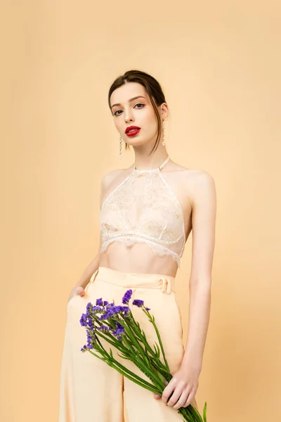 Young Woman Holding Limonium Flowers Standing Hand Pocket Isolated Beige — Stockfoto