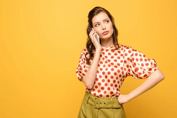 Pensive Young Woman Looking Away While Talking Smartphone Isolated Yellow — 스톡 사진