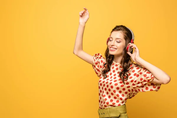 Cheerful Young Woman Wireless Headphones Dancing Closed Eyes Isolated Yellow — Stock Photo, Image
