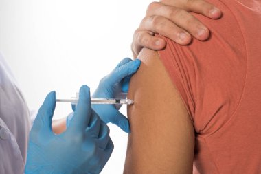 Cropped view of doctor doing vaccine injection in shoulder of patient isolated on white clipart