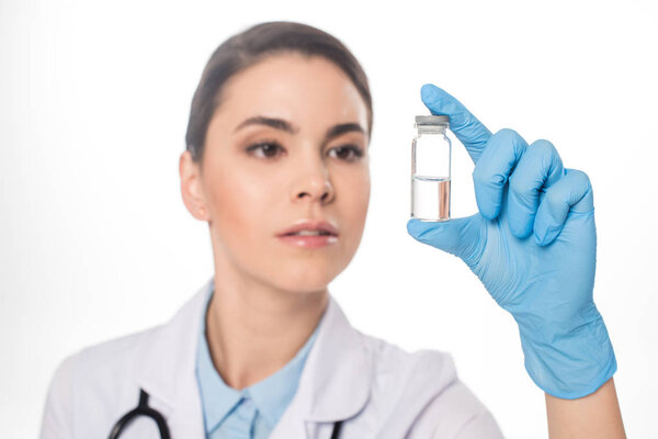 Selective focus of doctor holding jar with vaccine isolated on white