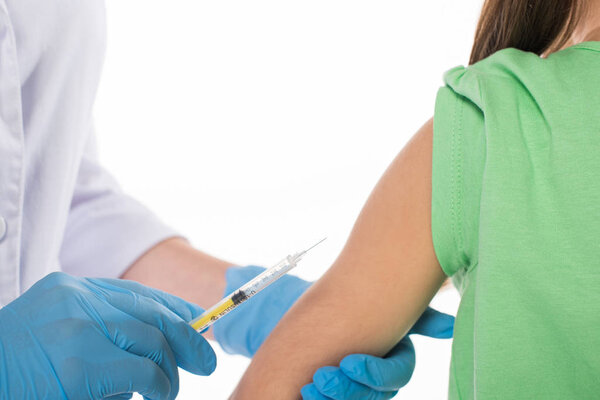 Cropped view of pediatrician doing injection with vaccine to kid isolated on white
