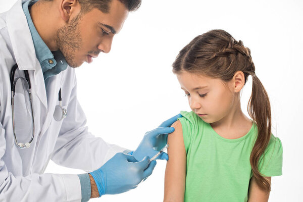 Pediatrician doing vaccine injection to child isolated on white