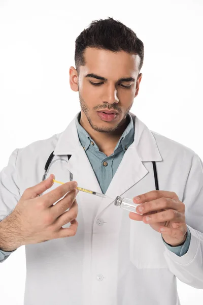 白色で単離された注射器でワクチンを拾うハンサムな医師 — ストック写真
