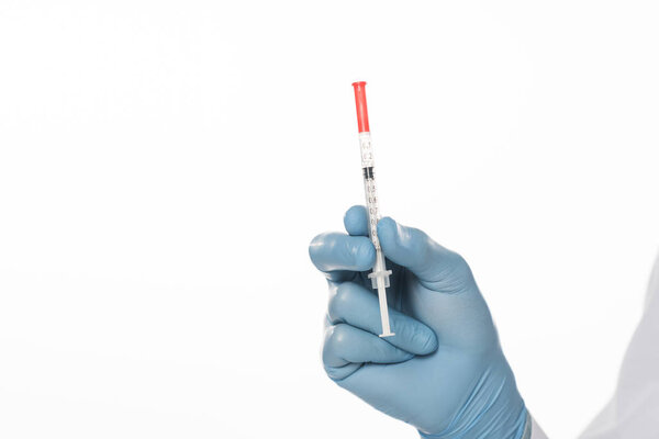Cropped view of doctor in latex glove holding syringe isolated on white