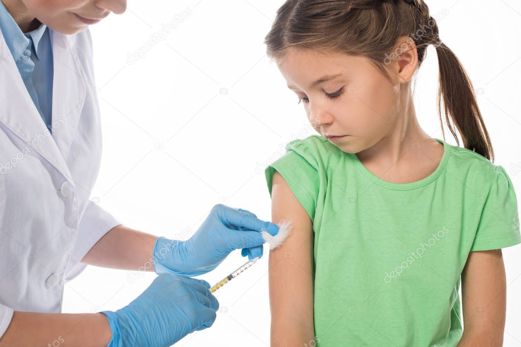 Pediatrician doing vaccine injection to kid isolated on white