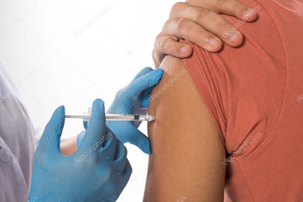 Cropped view of doctor doing vaccine injection in shoulder of patient isolated on white