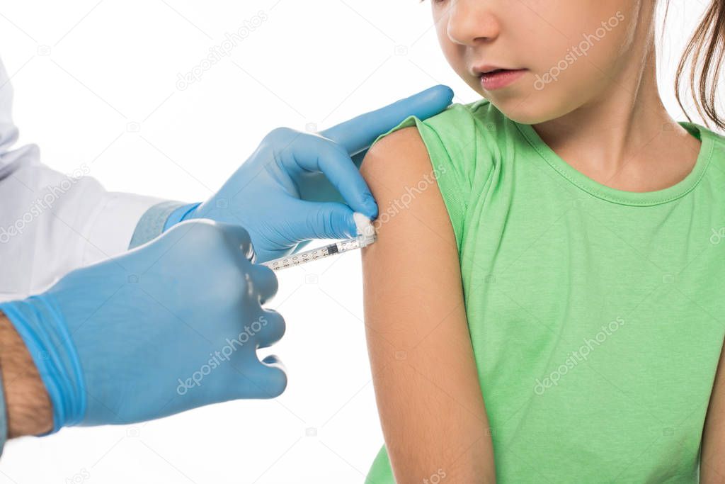 Cropped view of pediatrician doing vaccine injection in kid shoulder isolated on white