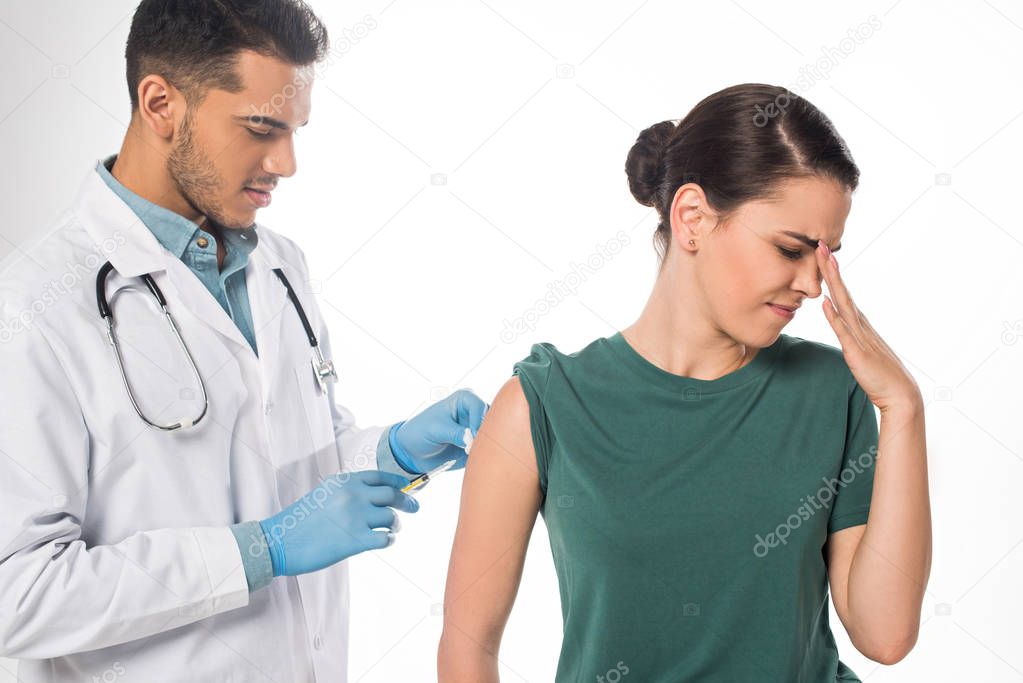 Doctor doing vaccine injection to scared patient isolated on white