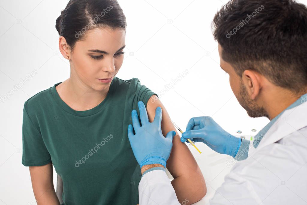 Doctor doing injection of vaccine to patient isolated on white