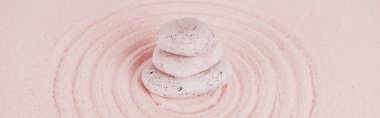 Panoramic shot of zen stones on pink sand with circles clipart