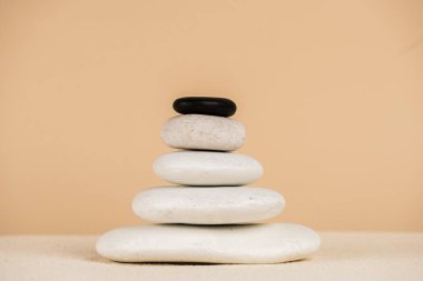 Zen stones on sand surface isolated on beige  clipart