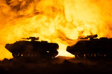 Battle scene with toy tanks and fire at background clipart