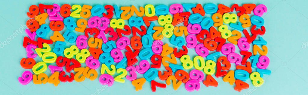 Top view of colorful numbers on blue background, panoramic shot