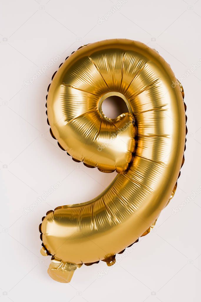 Decorative balloon in shape of nine number on grey background