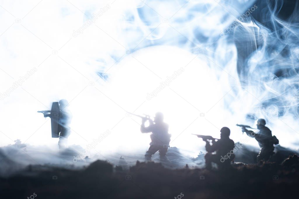 Battle scene with toy soldiers in smoke on black background