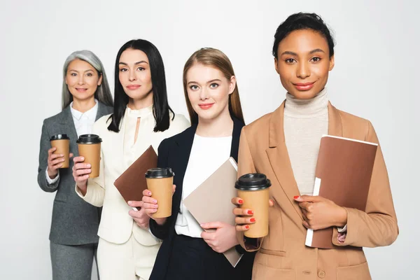 Cuatro Empresarias Felices Multiculturales Sosteniendo Carpetas Vasos Papel Aislados Blanco — Foto de Stock