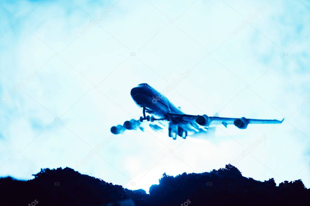 Battle scene with toy plane with smoke on blue background