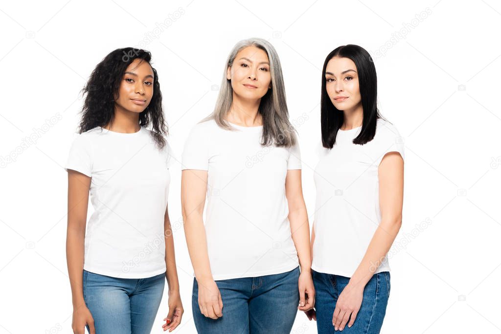 Beautiful multicultural women looking at camera isolated on white