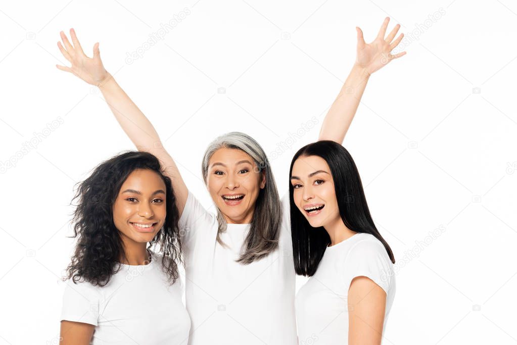 excited multicultural women looking at camera isolated on white 