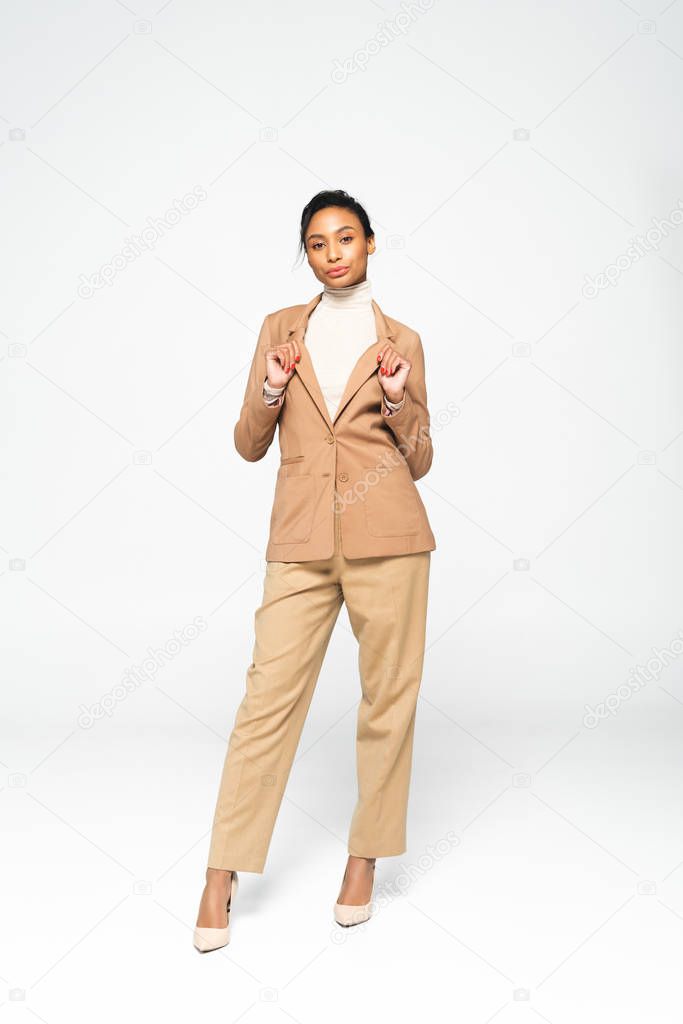 attractive african american businesswoman posing on white 