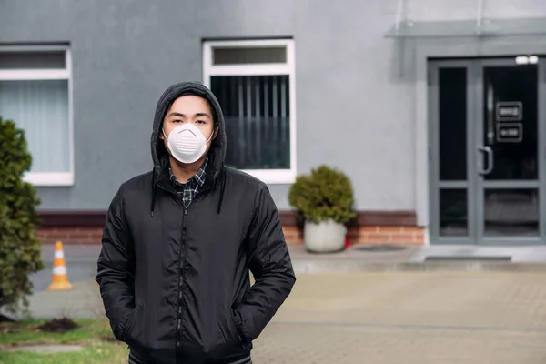 Young Asian Man Respirator Mask Looking Camera Holding Hands Pockets — Stock Photo, Image