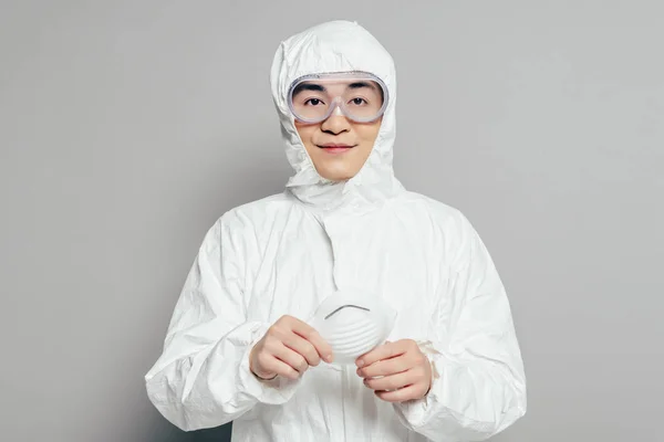 Asian Epidemiologist Hazmat Suit Holding Respirator Mask While Looking Camera — Stock Photo, Image