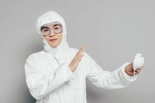 Asian Epidemiologist Hazmat Suit Showing Gesture While Holding Respirator Mask — ストック写真