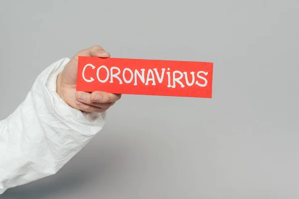 Cropped View Epidemiologist Holding Warning Card Coronavirus Inscription Grey Background — Free Stock Photo