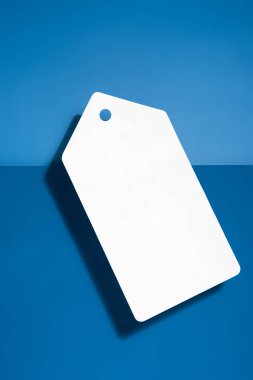 white big blank price tag on blue background