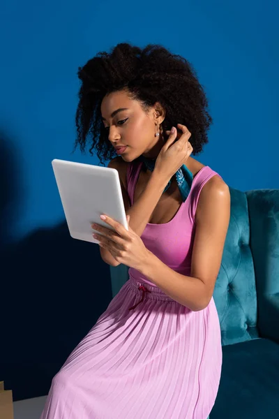 African American Woman Sitting Velour Armchair Digital Tablet Blue Background — Stockfoto