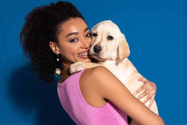 Smiling African American Woman Braces Holding Golden Retriever Puppy Blue — Stok fotoğraf