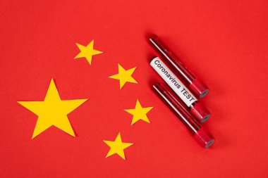 Kırmızı Çin bayrağı yakınlarında Coronavirus test harfleri olan numunelerin üst görünümü 