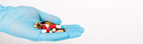 Panoramiczne Ujęcie Naukowca Niebieskiej Rękawiczce Lateksem Trzymającego Tabletki Odizolowane Białym — Zdjęcie stockowe