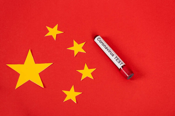 top view of sample with coronavirus test lettering near red chinese flag 
