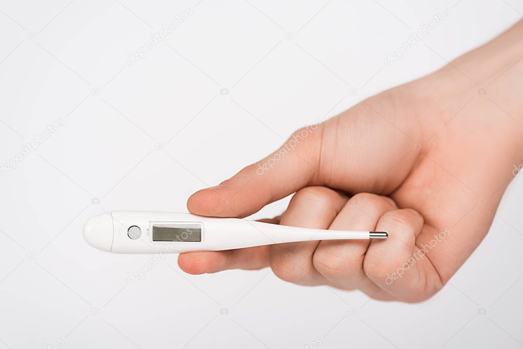 cropped view of woman holding digital thermometer isolated on white 