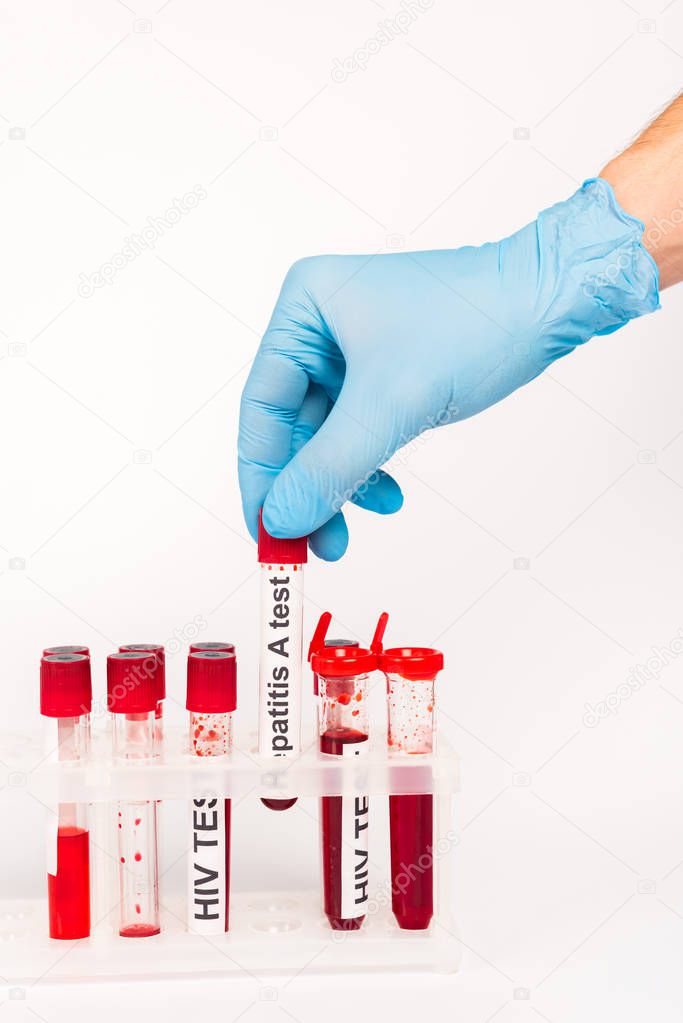 cropped view of scientist in blue latex glove holding sample with hepatitis a test lettering isolated on white 