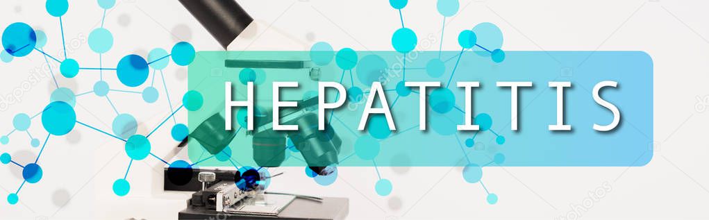 Panoramic shot of modern microscope near hepatitis lettering on white