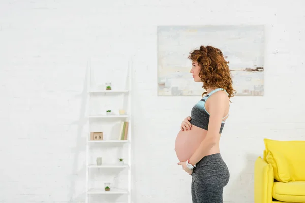 Side View Pregnant Woman Sportswear Touching Belly Living Room — Stock Photo, Image