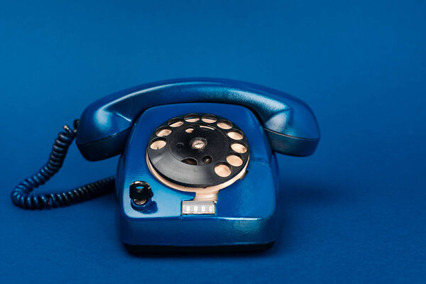bright and colorful retro telephone on blue background 