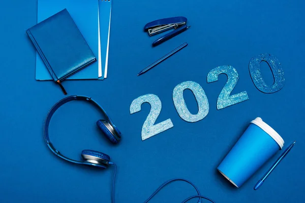 Top View Notebooks Headphones Pens Stapler 2020 Numbers Blue Background — Stock Photo, Image