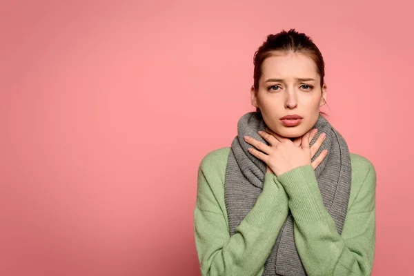 Sick girl with sore throat touching neck wrapped in warm scarf isolated on pink — Stock Image Sick Girl Sore Throat Touching Neck Wrapped Warm Scarf Isolated Royalty Free Stock Photos