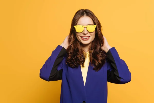 Happy Stylish Girl Yellow Glasses Touching Hair While Looking Camera — Stock Photo, Image