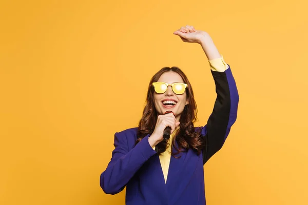 Young Singer Yellow Glasses Singing Raised Hand Isolated Yellow — Stock Photo, Image