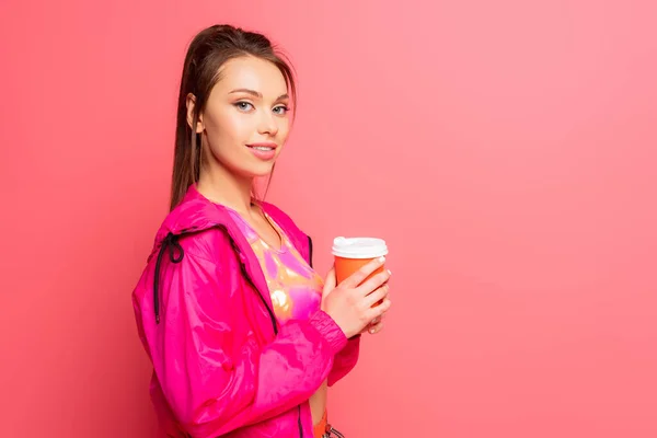 Pretty Smiling Sportswoman Holding Coffee While Looking Camera Pink Background — Stock Photo, Image