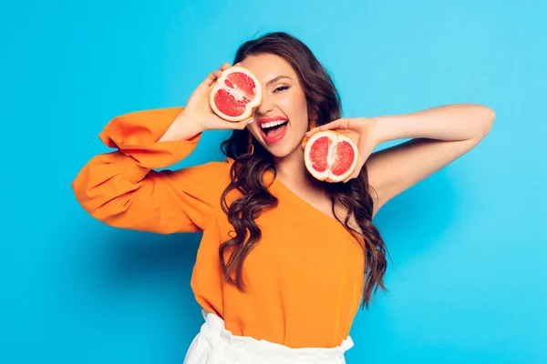 Excited Girl Covering Eye Half Ripe Pineapple Blue Background — Stock Photo, Image